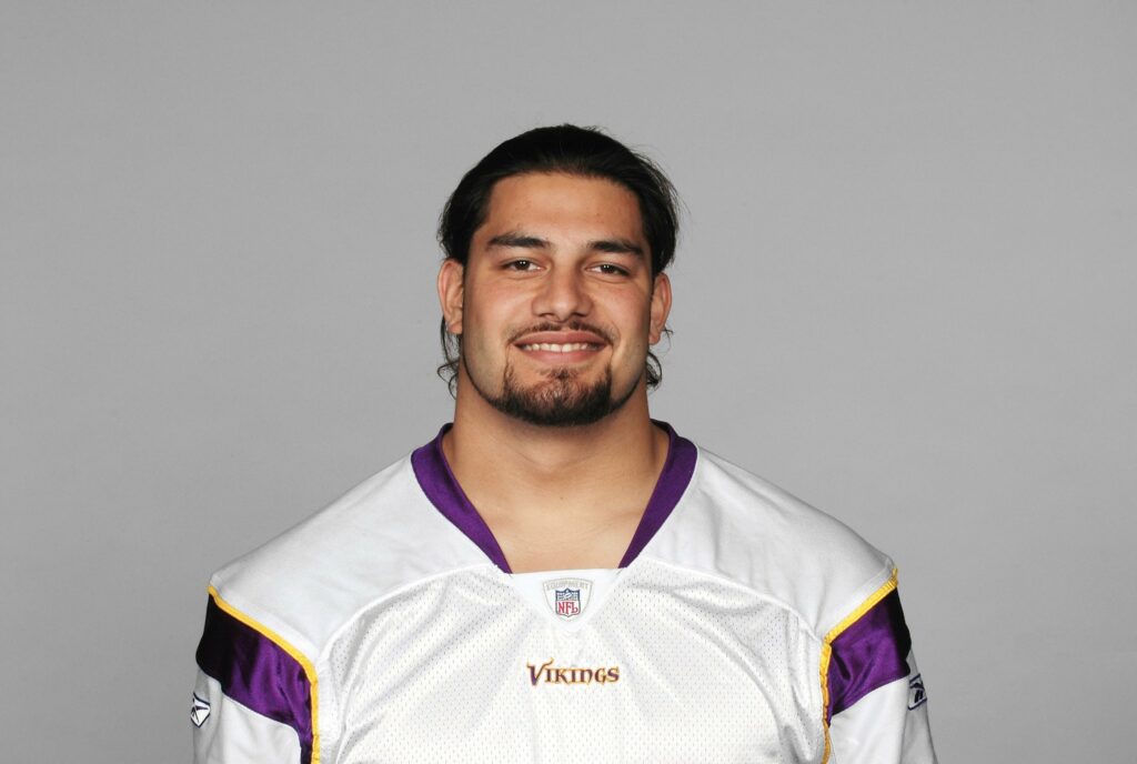 Which NFL team did Roman Reigns play football for?
