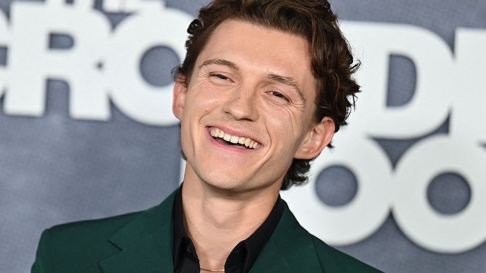 Tom Holland all smiles at an event