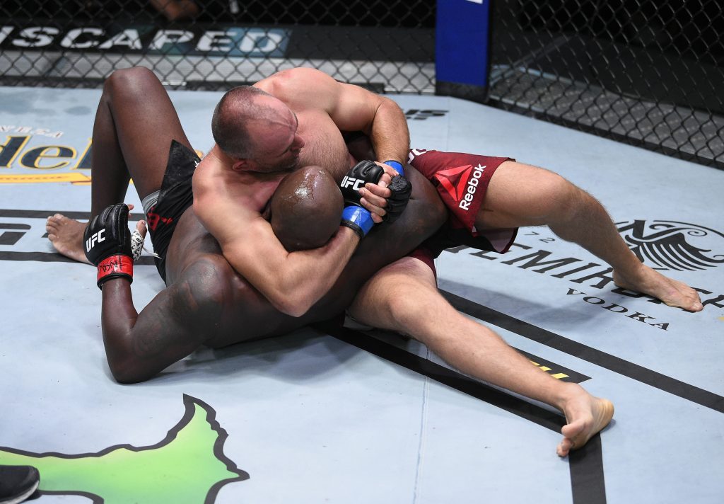 Aleksei Oleinik tries to submit Derrick Lewis