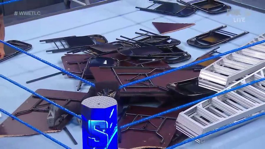 Kevin Owens was buried under a mountain of chairs, tables and ladders