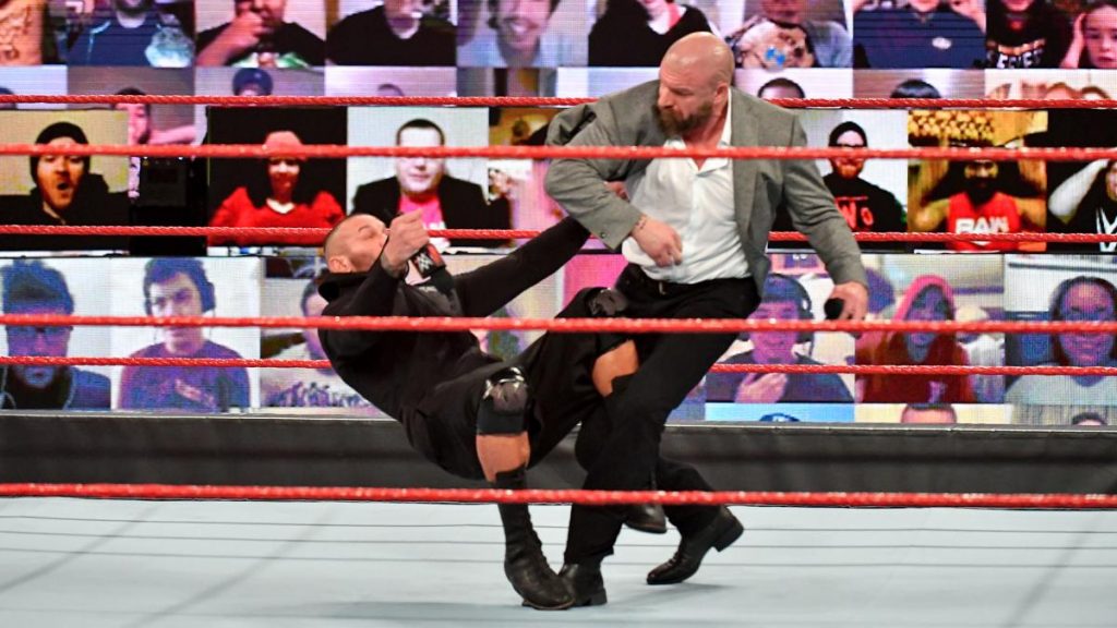 Triple H punches Randy Orton