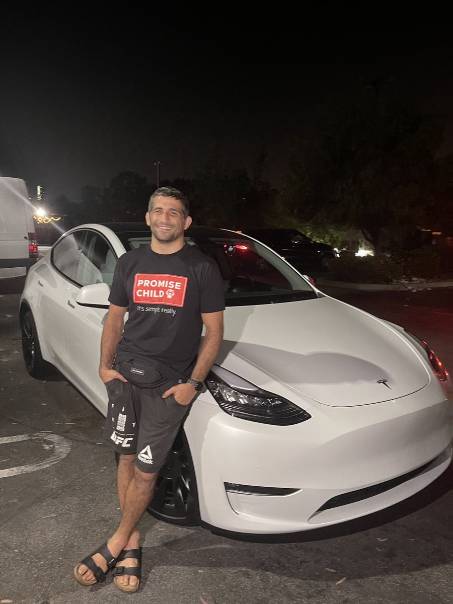 Beneil Dariush with his free Tesla