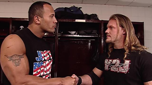Chris Jericho and Dwayne 'The Rock' Johnson doing their 'cool' handshake backstage.
