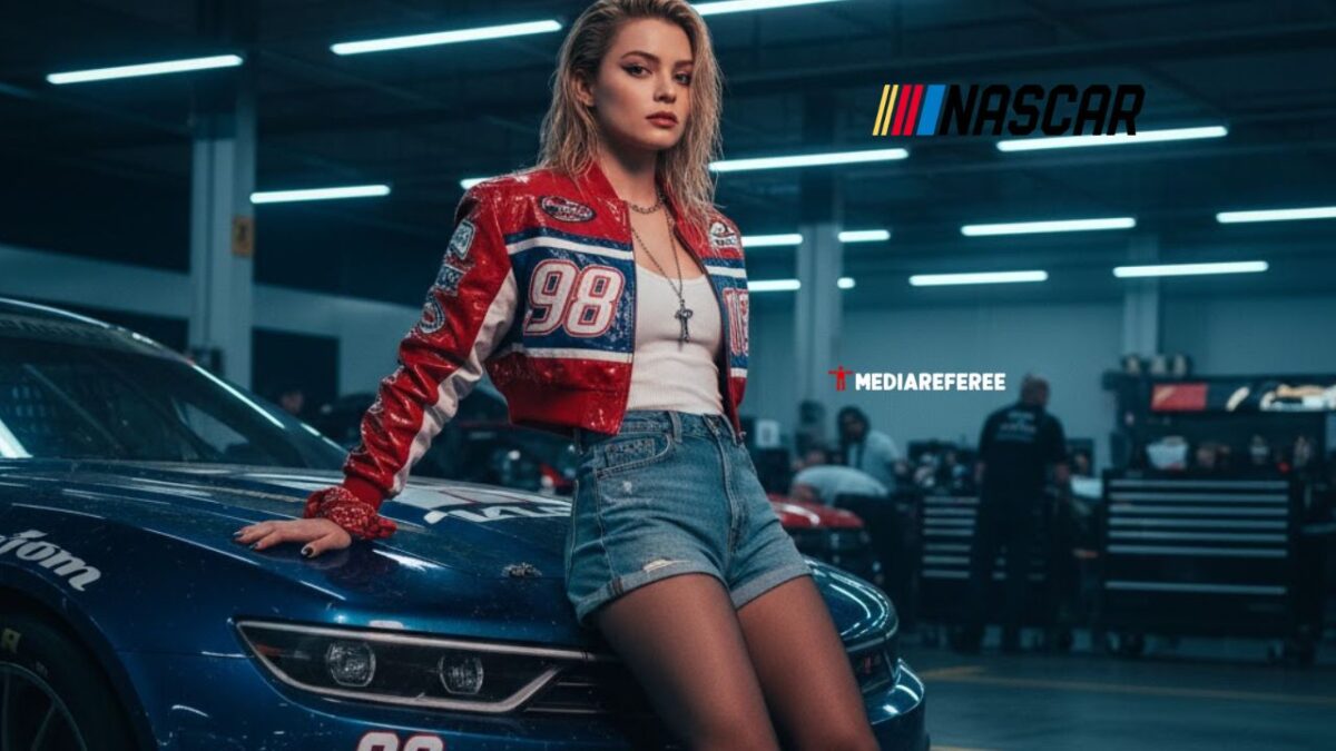 Sydney Sweeney sitting in front of car with a NASCAR Outfit