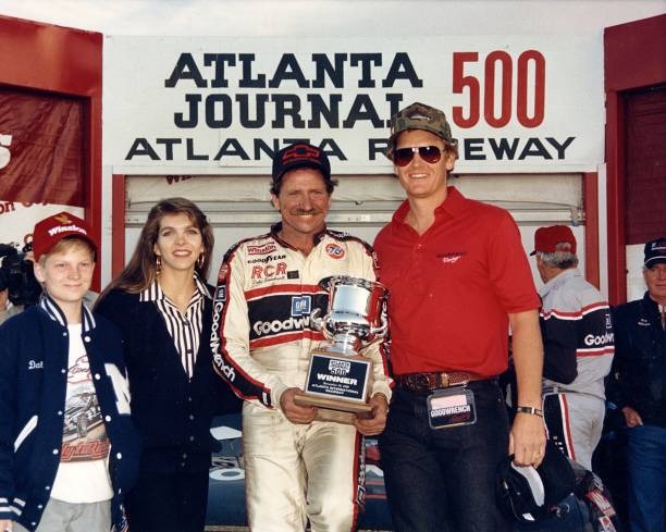 Dale Earnhardt, Sr. Accepts Trophy with a Young Dale Earnhardt, Jr.