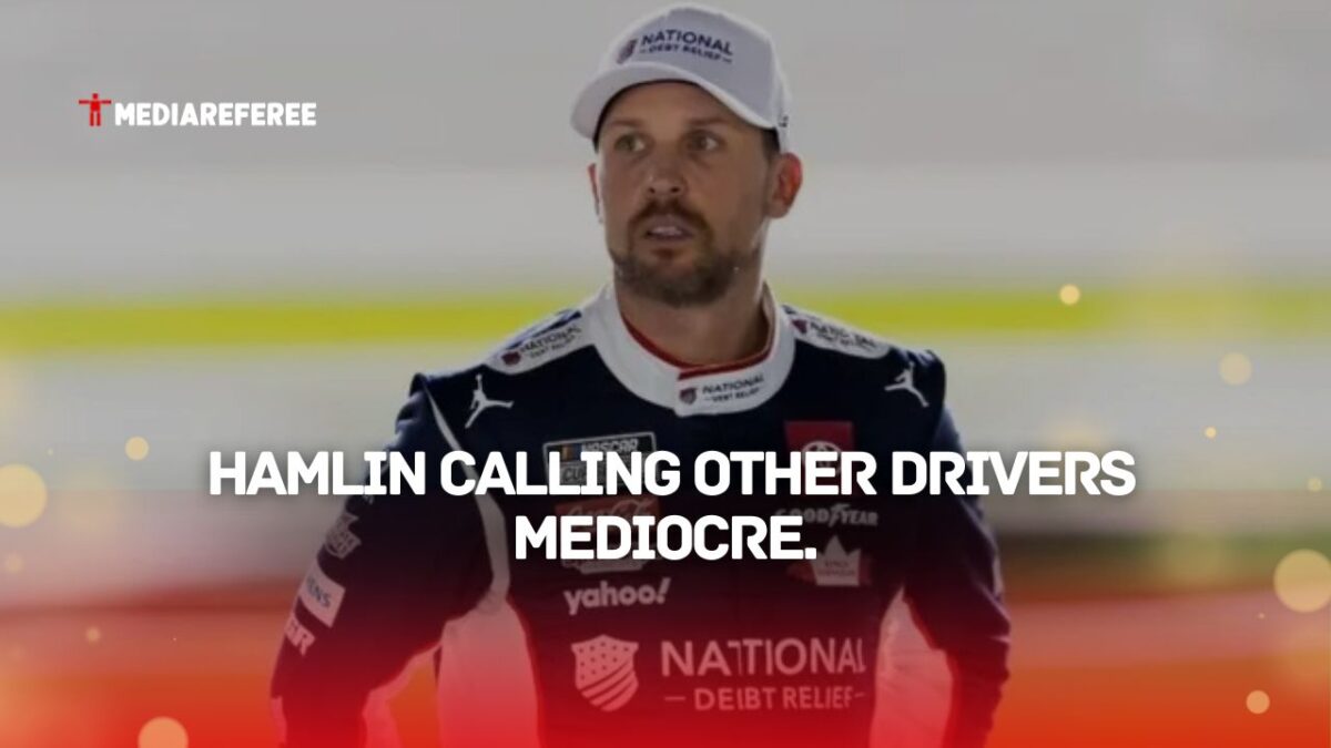 Denny Hamlin standing in his gear