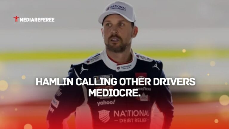 Denny Hamlin standing in his gear