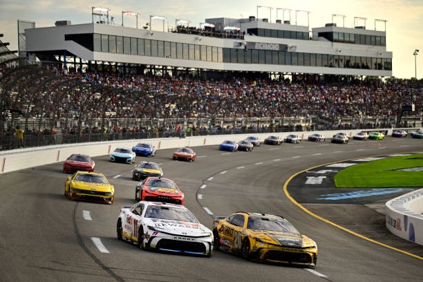 Denny Hamlin, driver of the #11 FedEx Rewards Toyota, and Christopher Bell, driver of the #20 DEWALT Carpentry Solutions Toyota, race during the NASCAR Cup Series Cook Out 400 at Richmond Raceway on August 11, 2024 in Richmond, Virginia.